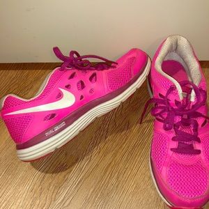 Hot pink Nike tennis shoes